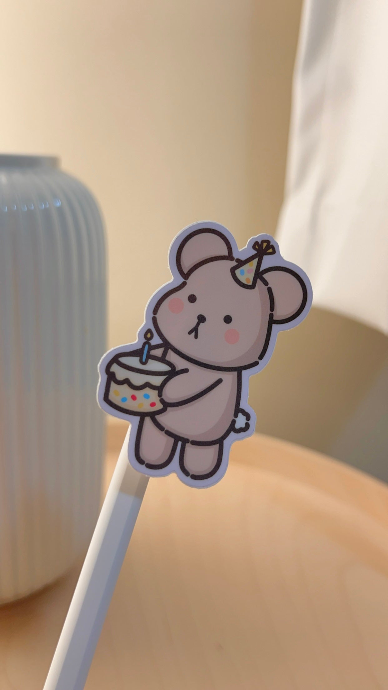 Wonki Studios' Birthday Taro sticker design shows Taro the Bear holding a cake to celebrate a birthday.